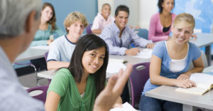 High School Students sitting in classroom listening to teacher