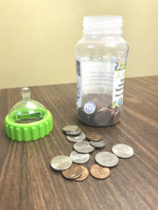 Baby bottle filled with coins.