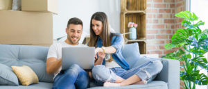 Couple sitting on couch looking over laptop
